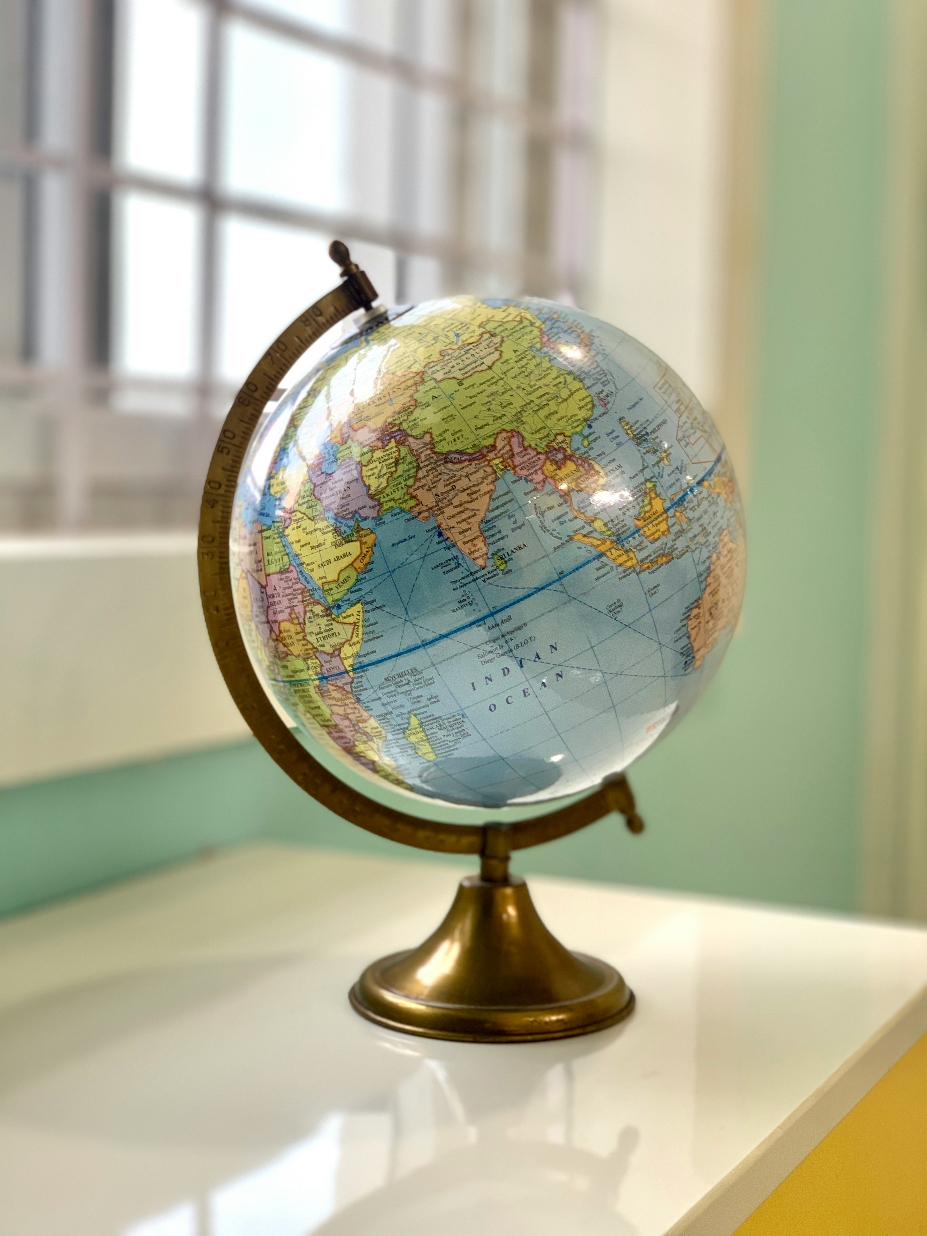 Desk globe standing on a table by a window